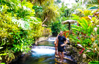 man and woman standing on water fountain during daytime