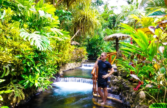 man and woman standing on water fountain during daytime in Alajuela Province Costa Rica