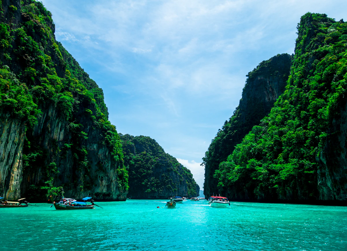 Dramatic limestone karst cliffs rising from the emerald Andaman Sea at Railay Bay, Krabi, Thailand