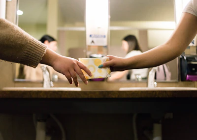 Close-up of hands exchanging hygiene kits with grateful recipients.