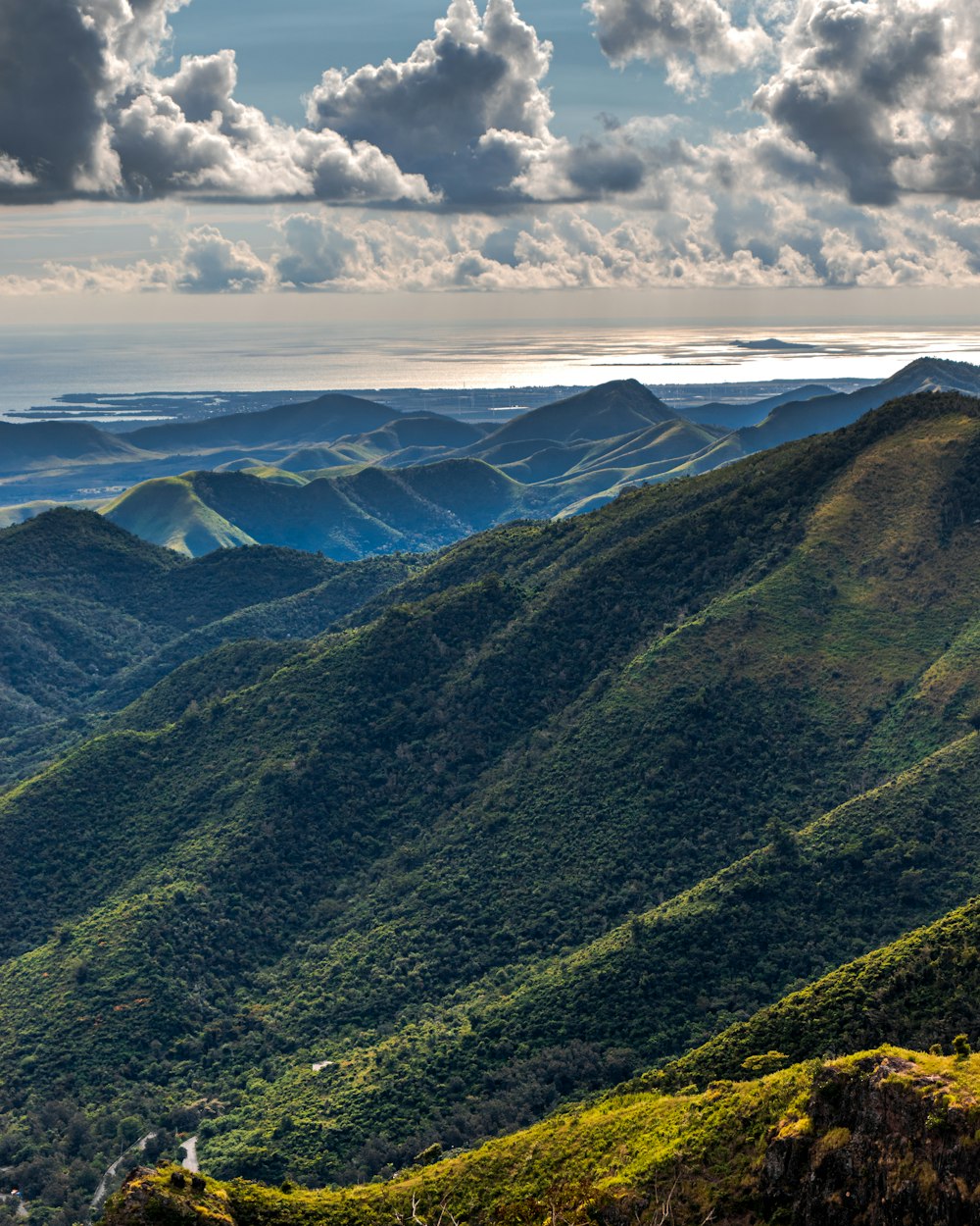 green mountains under white clouds during daytime