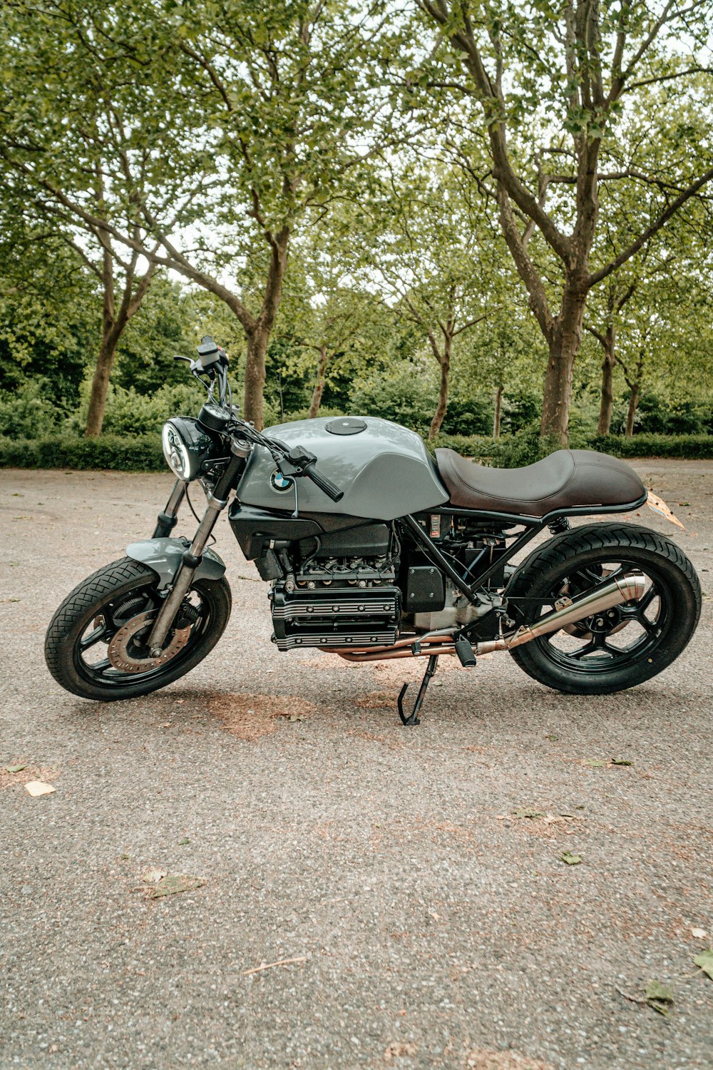 black and gray motorcycle parked on brown dirt road during daytime