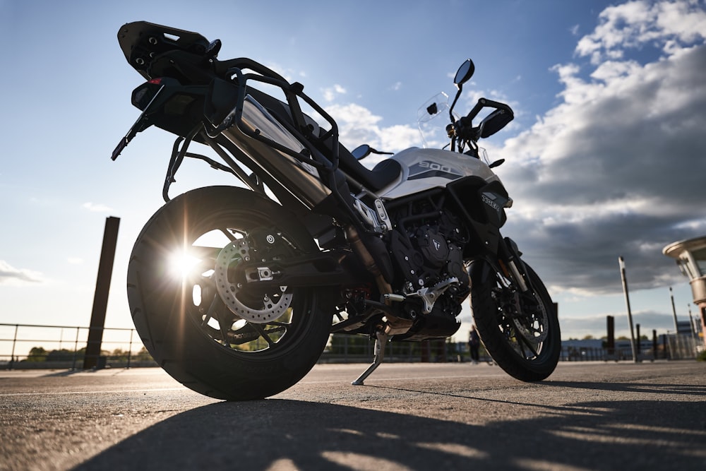 black and white motorcycle on brown dirt road during daytime