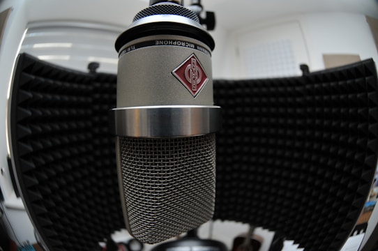 Recording studio microphone with soundproof panels in the background.