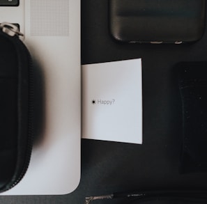 black zip pouch on white table