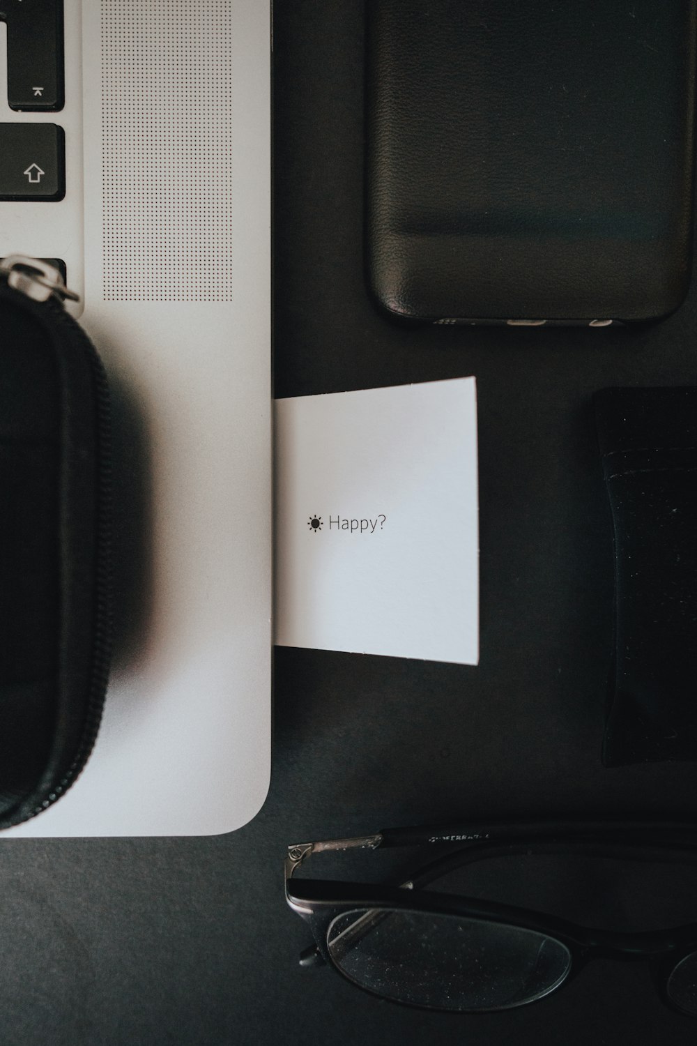 black zip pouch on white table