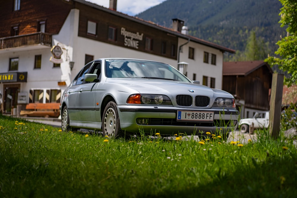 silver bmw m 3 coupe parked on green grass field during daytime