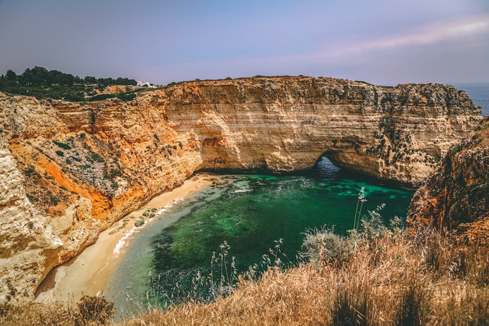 brown rock formation beside blue sea during daytime