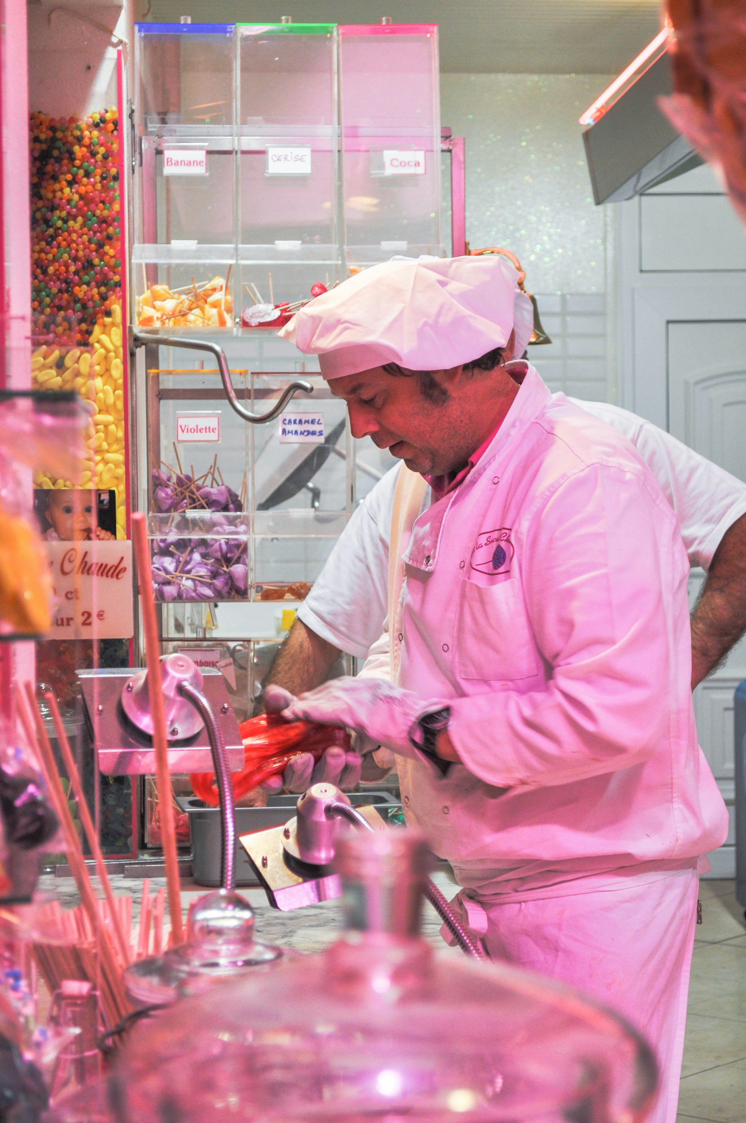 man in pink dress shirt holding stainless steel kettle