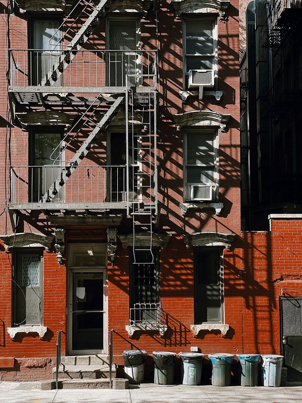 brown brick building with black metal window grills