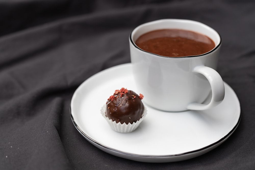 white ceramic cup with brown liquid inside