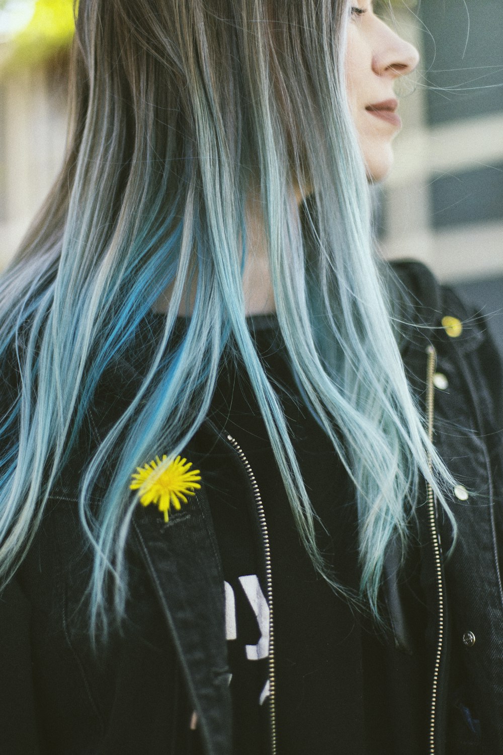 woman in black jacket with blue hair