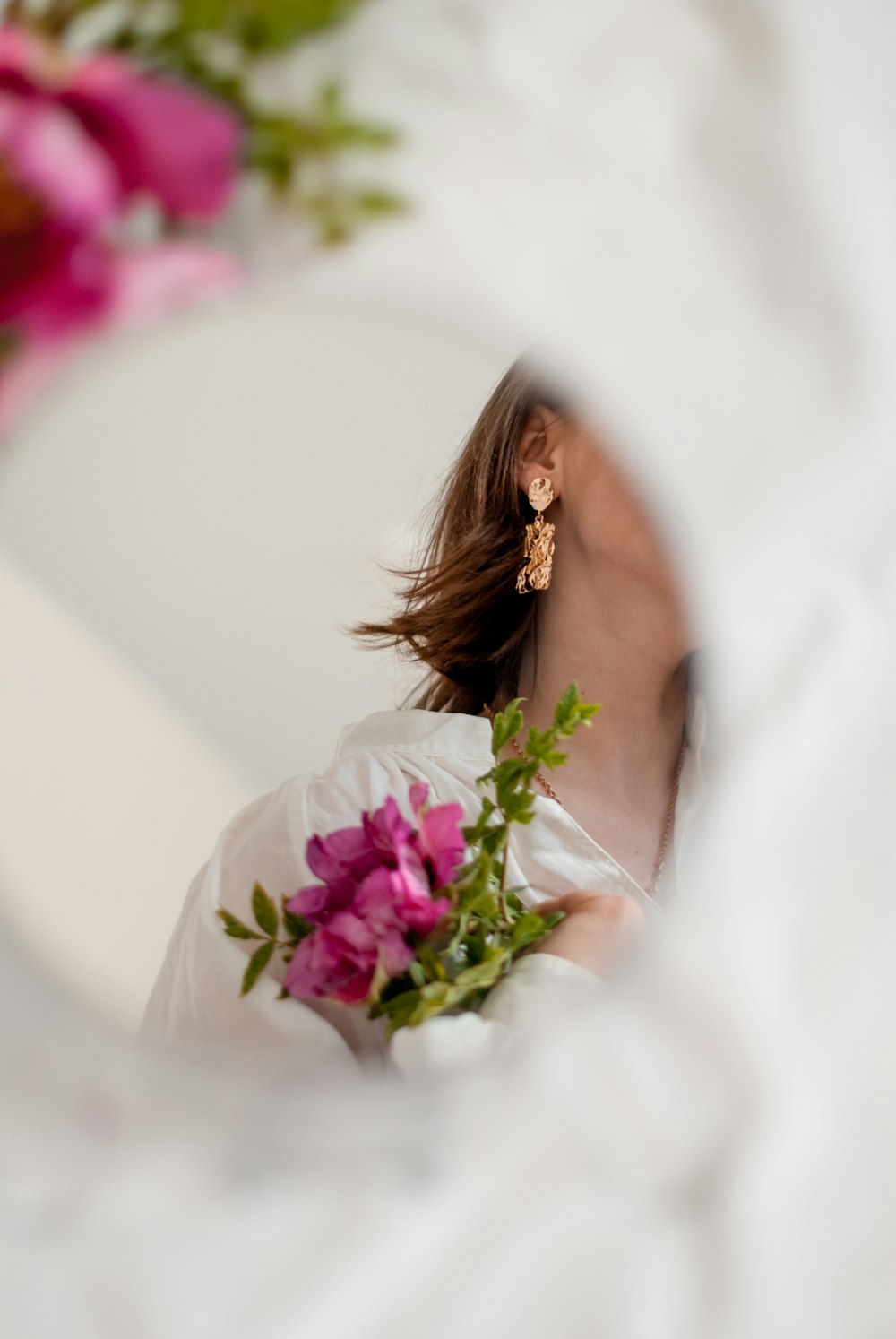 woman in white wedding dress holding bouquet of flowers