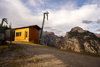 A sleek outdoor TV lift cabinet installed on a sunny Castle Rock patio with mountains in the background.