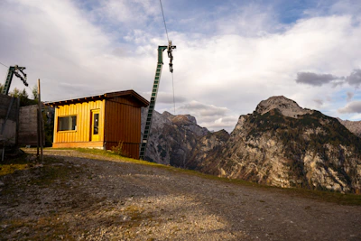 A sleek outdoor TV lift cabinet installed on a sunny Castle Rock patio with mountains in the background.