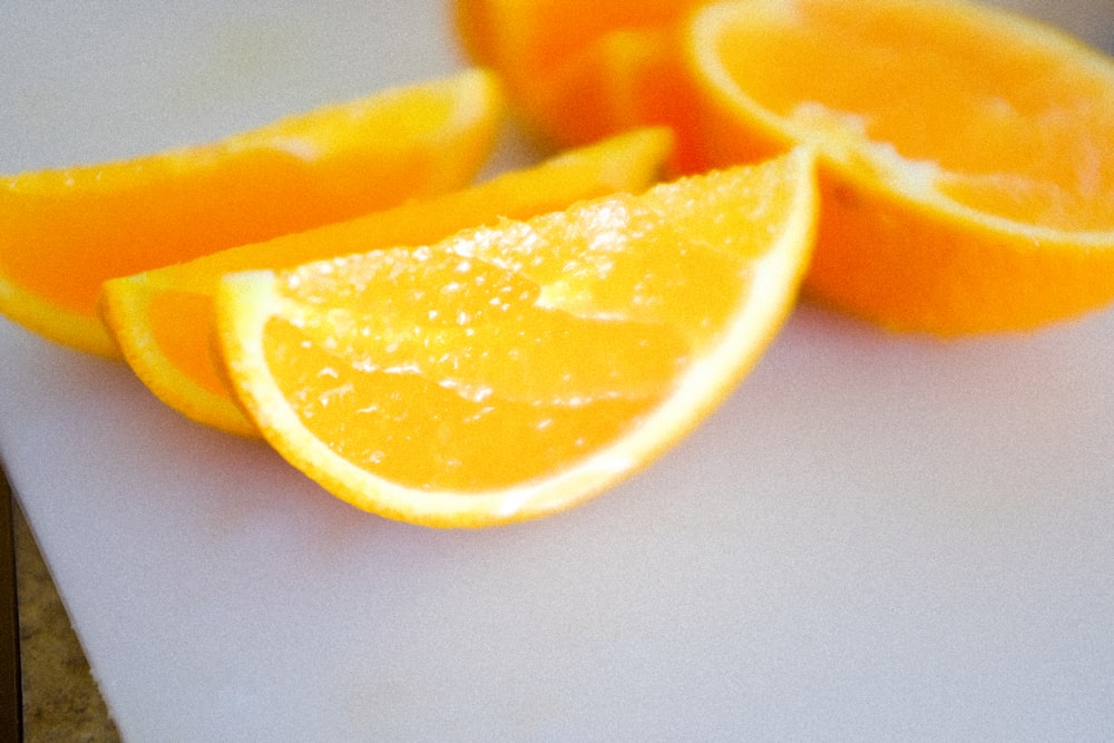 sliced orange fruit on white surface