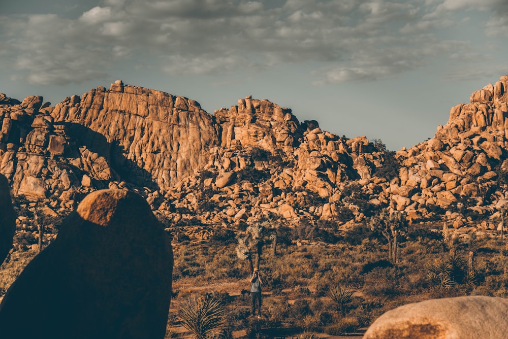 brown rock formation under white clouds during daytime