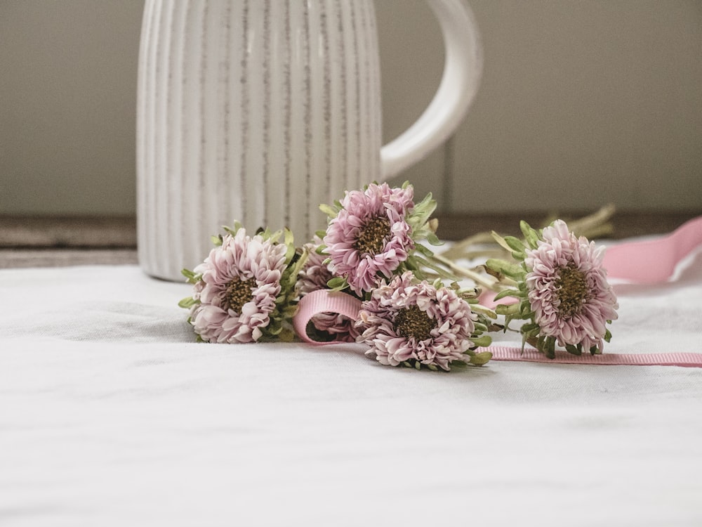 pink flowers in white ceramic vase