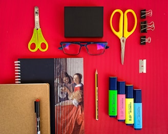 yellow plastic hair comb beside black ipad