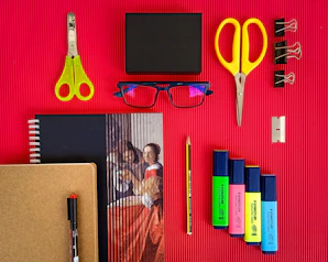yellow plastic hair comb beside black ipad