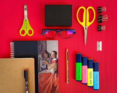 yellow plastic hair comb beside black ipad