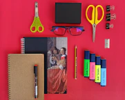 yellow and red scissors and black pen