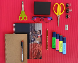 yellow and red scissors and black pen