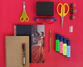 yellow and red scissors and black pen