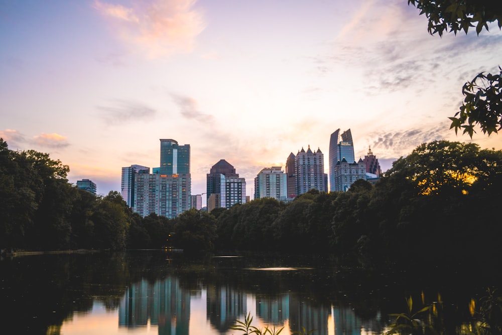 body of water near trees and buildings during daytime