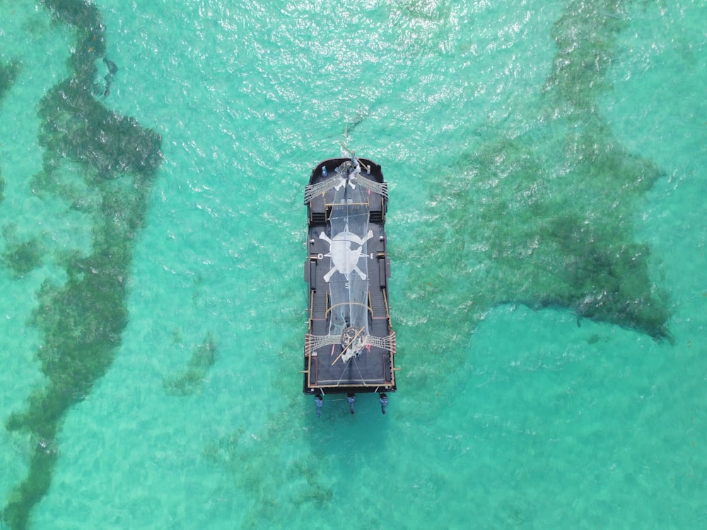aerial view of gray and black boat on body of water during daytime