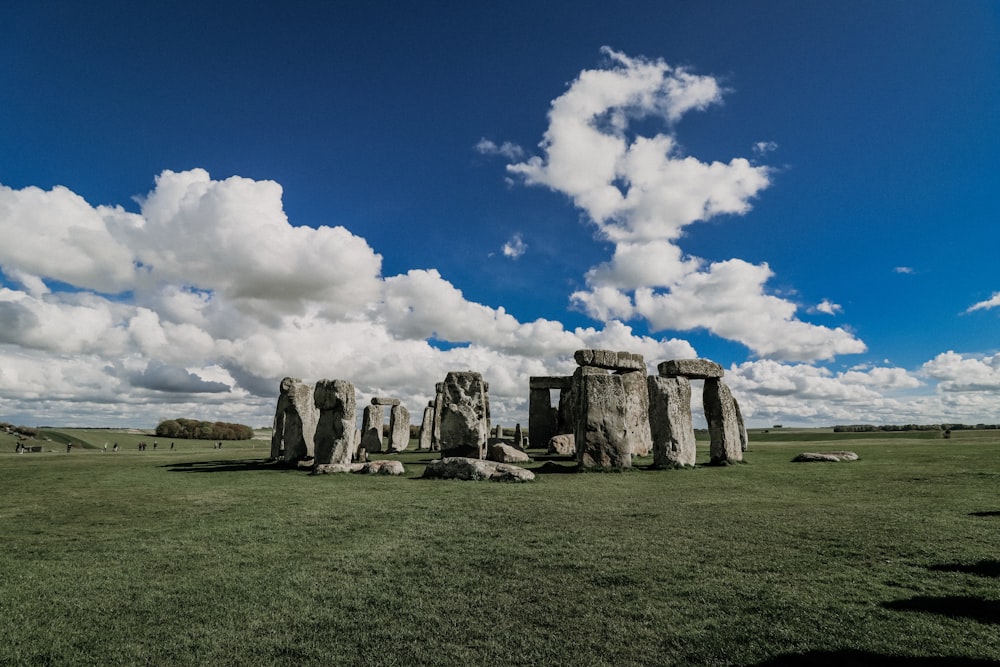 gray rock formation under blue sky and white clouds during daytime