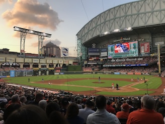 people watching football game during daytime