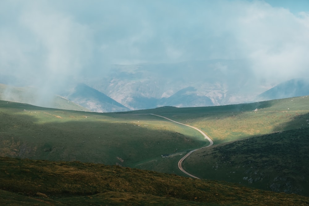 green mountains under white clouds during daytime