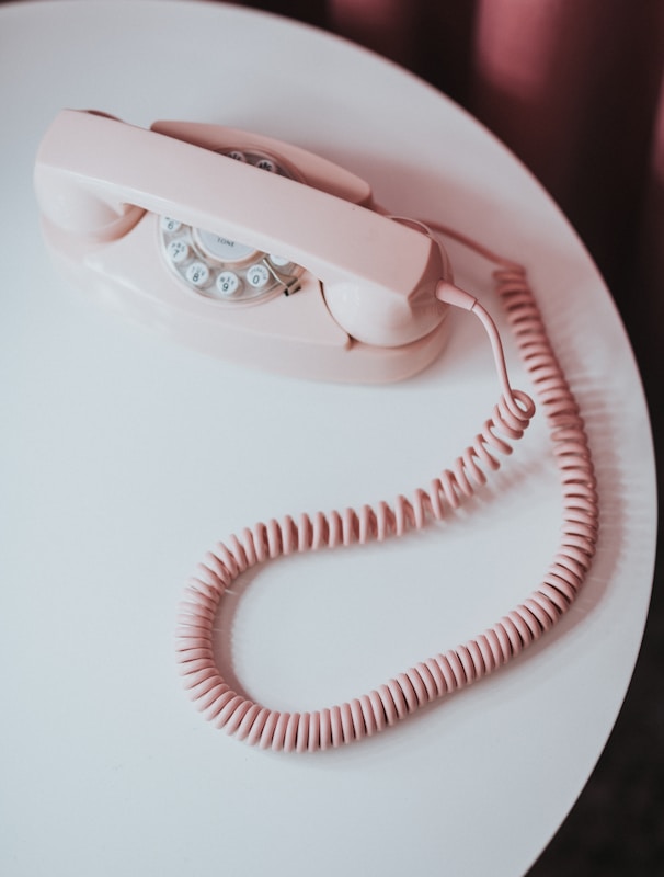 white and pink rotary phone