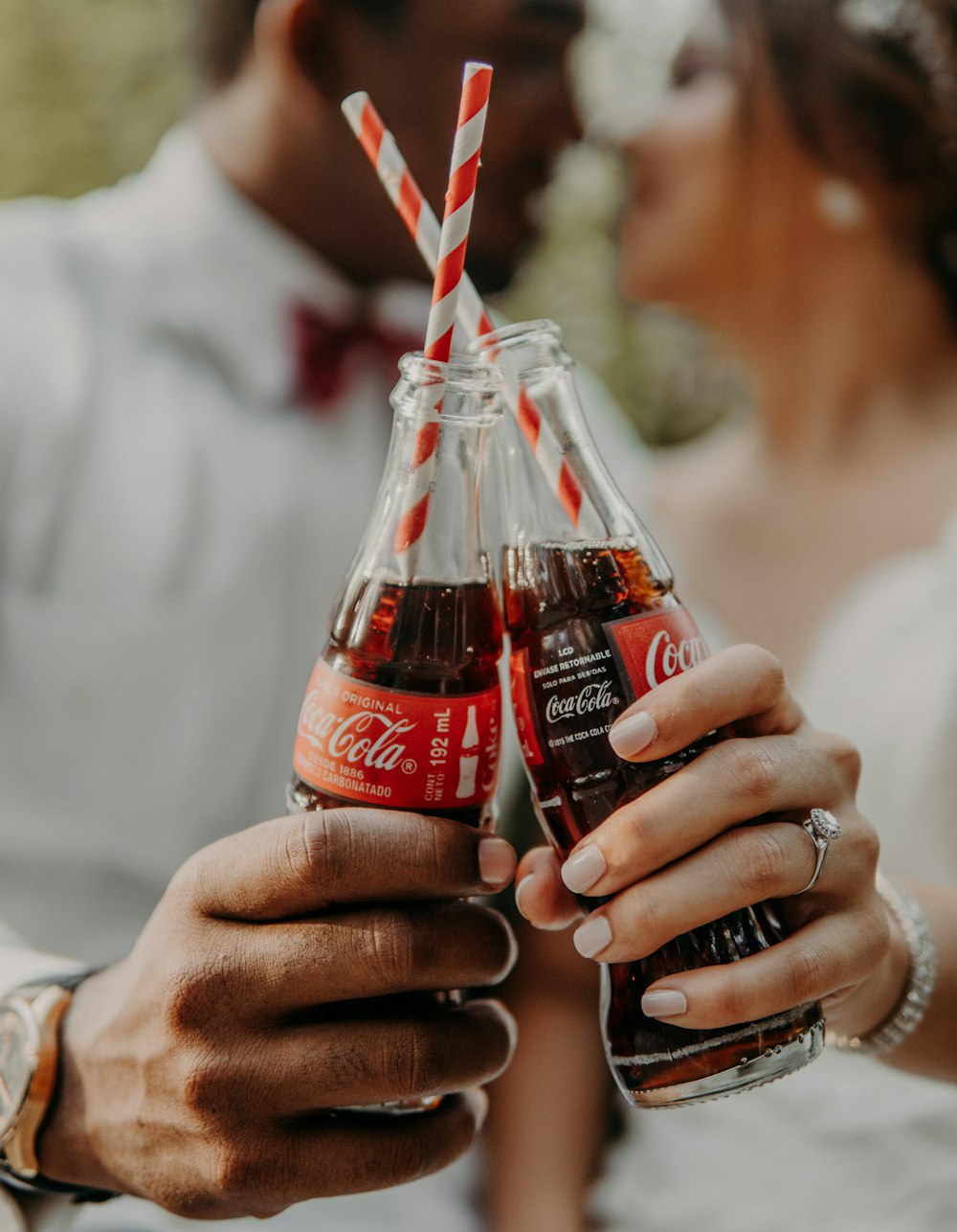 person holding coca cola bottle