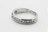 A minimalist engagement ring with a sleek band and a small, sparkling round diamond.