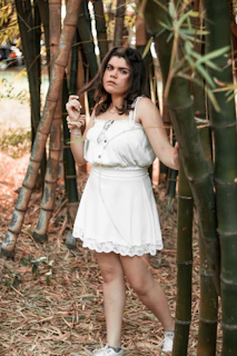 Model wearing a flowing dress made from bamboo fabric in a serene outdoor setting.