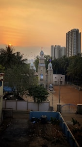 A serene morning view of Saint Thomas Mount Church bathed in soft sunlight with worshippers gathering.