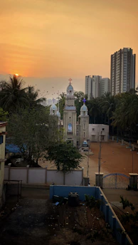 A serene view of the Parroquia Sagrada Eucaristis church surrounded by greenery.