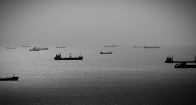 Logistics coordination illustrated by cargo ships and fuel pipelines at dusk.