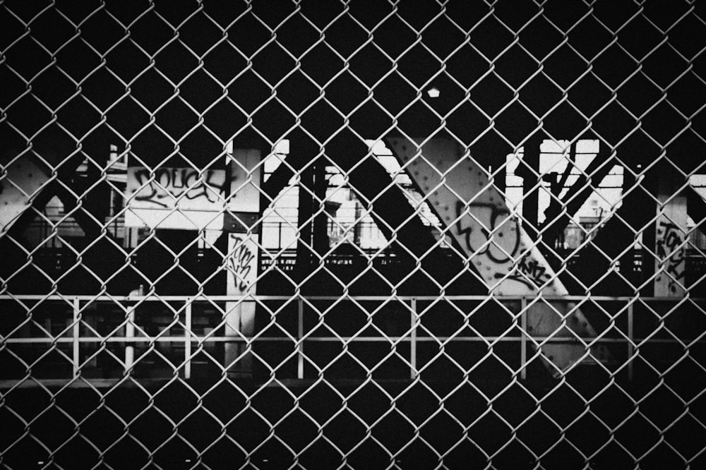 grayscale photo of chain link fence