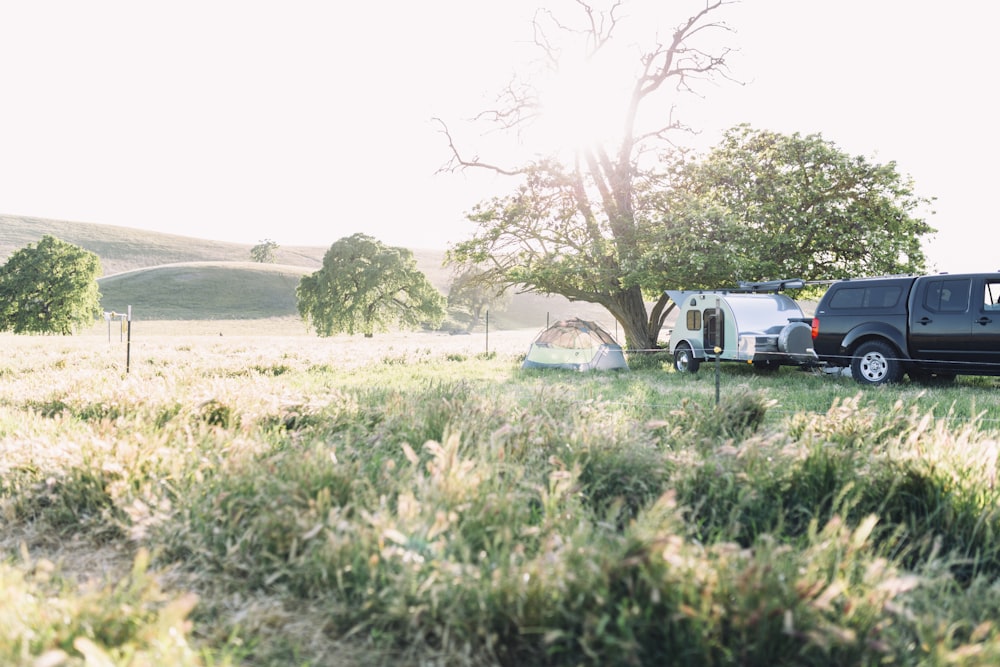 white van parked beside green grass field during daytime