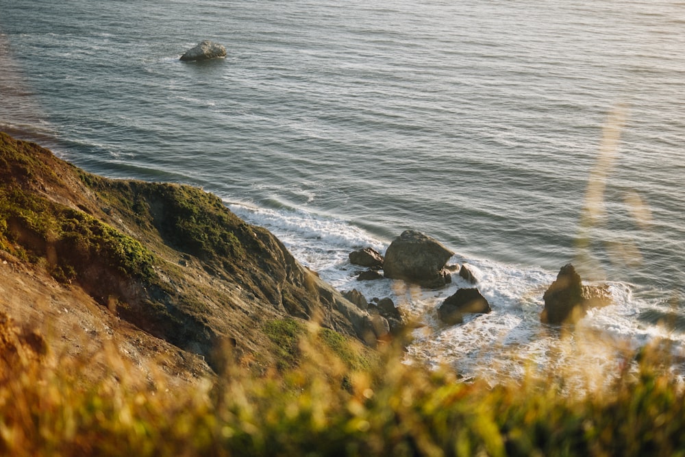 brown rock formation near body of water during daytime