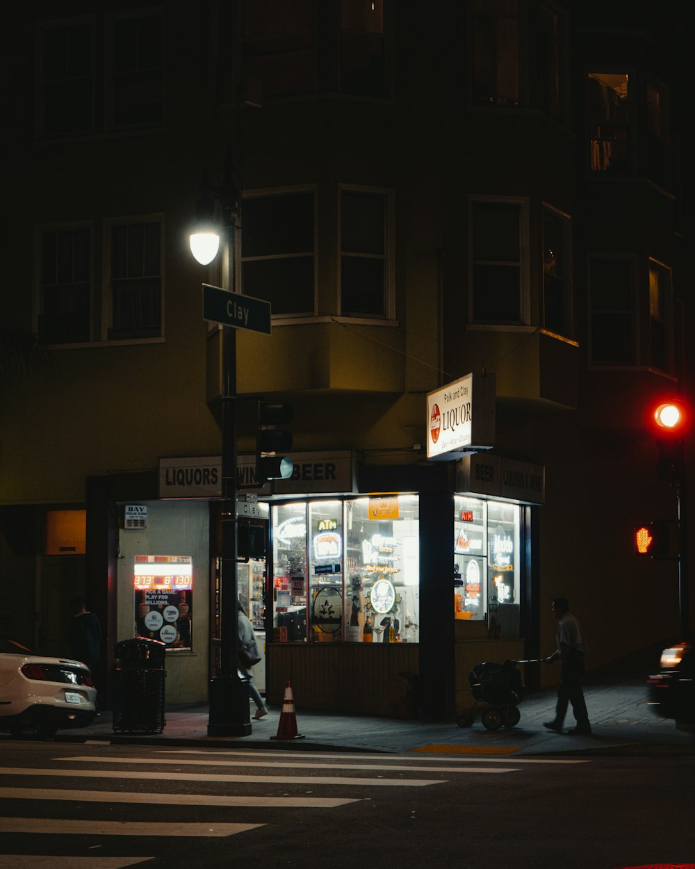 people walking on sidewalk near building during night time