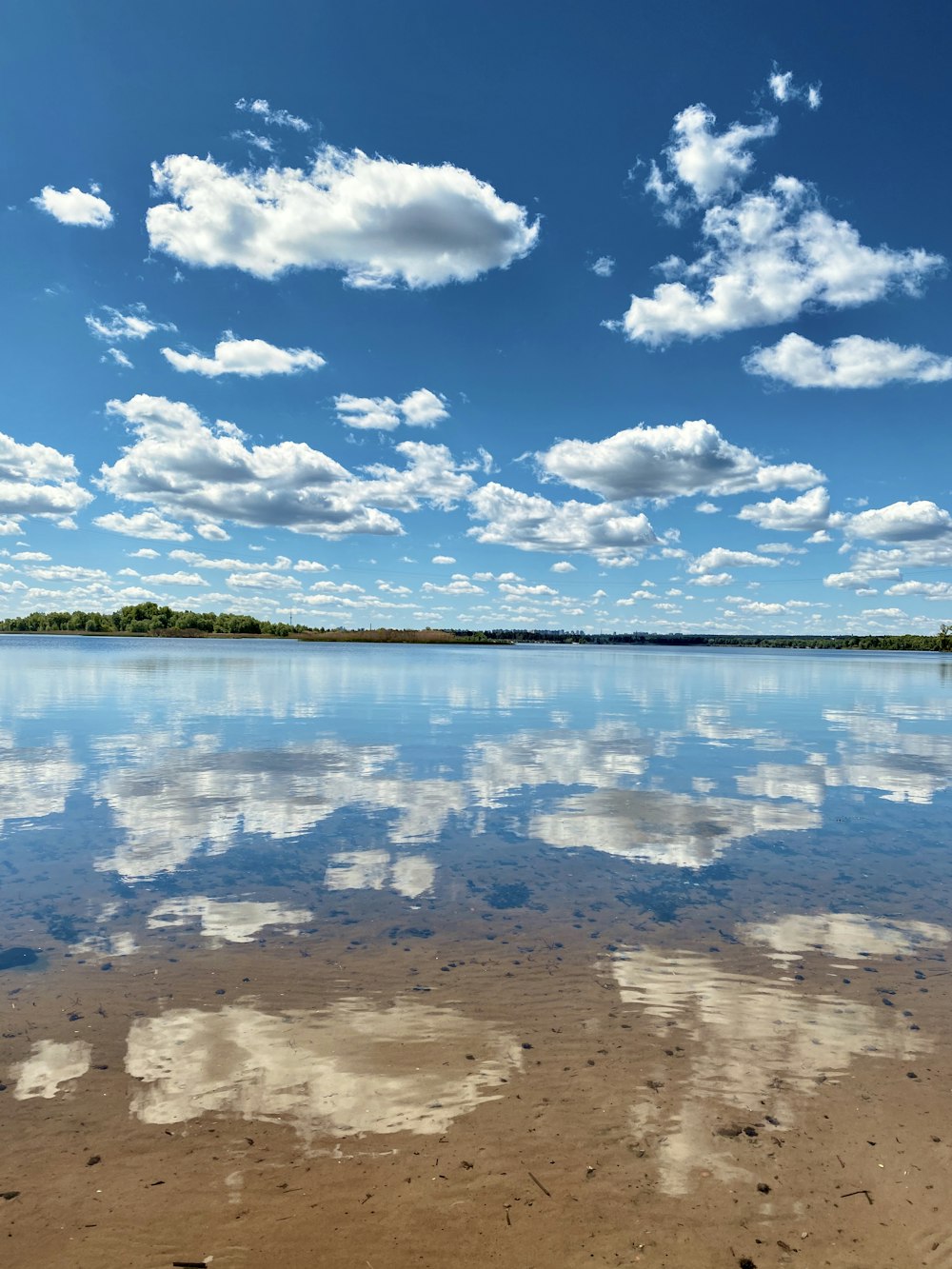 blue body of water under blue sky during daytime