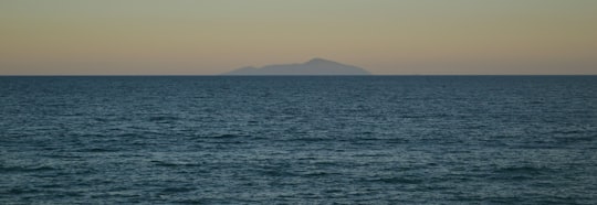 body of water near mountain during daytime in Ubatuba Brasil