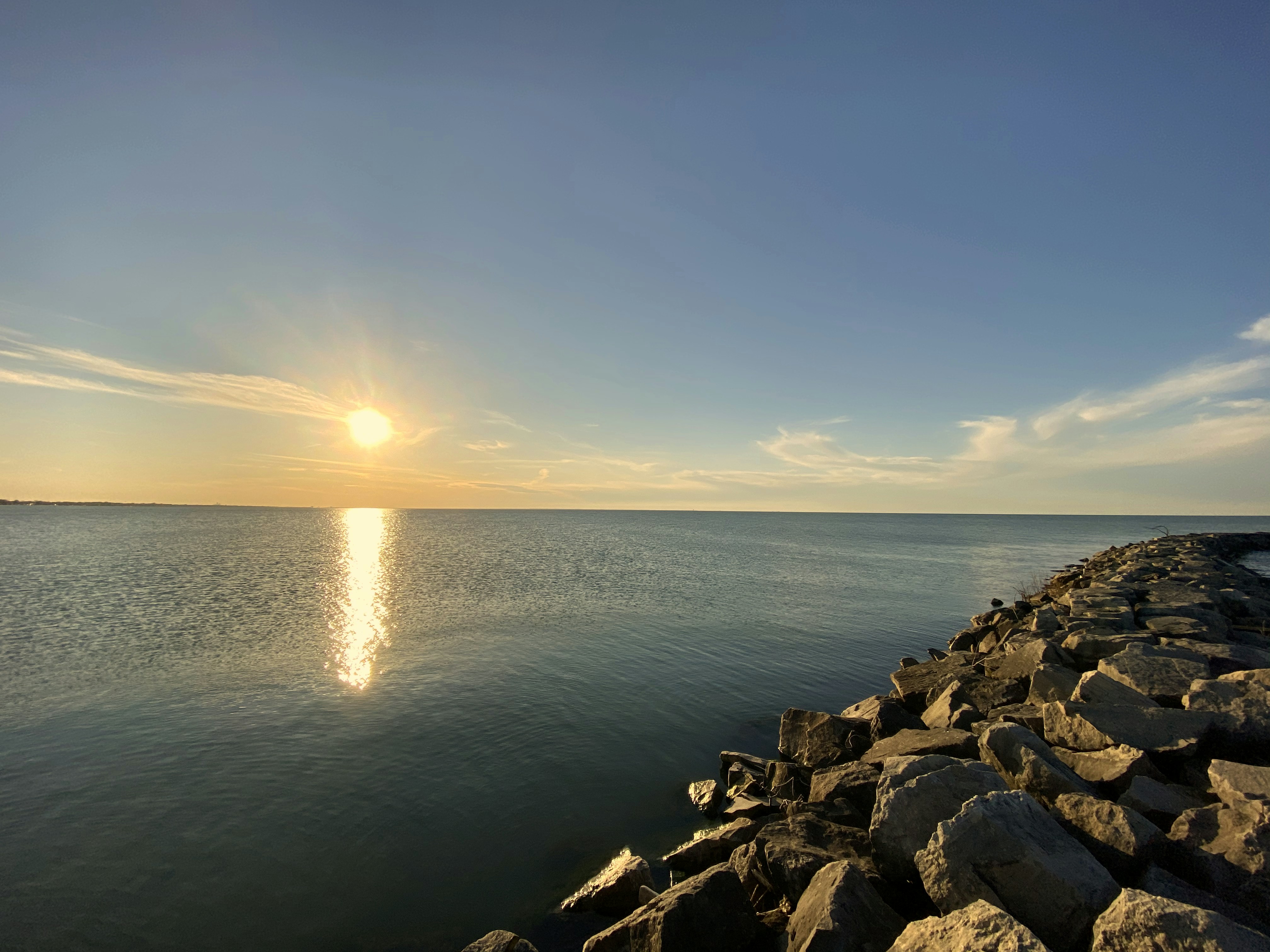 gray rocks near body of water during daytime