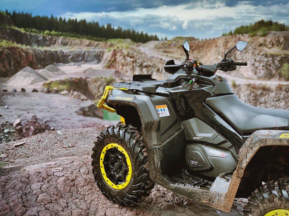 black and yellow atv on brown dirt road during daytime