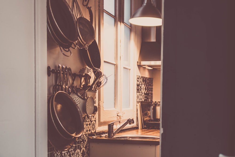 black and white pendant lamp turned on near brown wooden cabinet