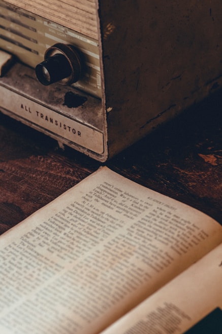 Vintage transistor radio resting on a retro patterned fabric